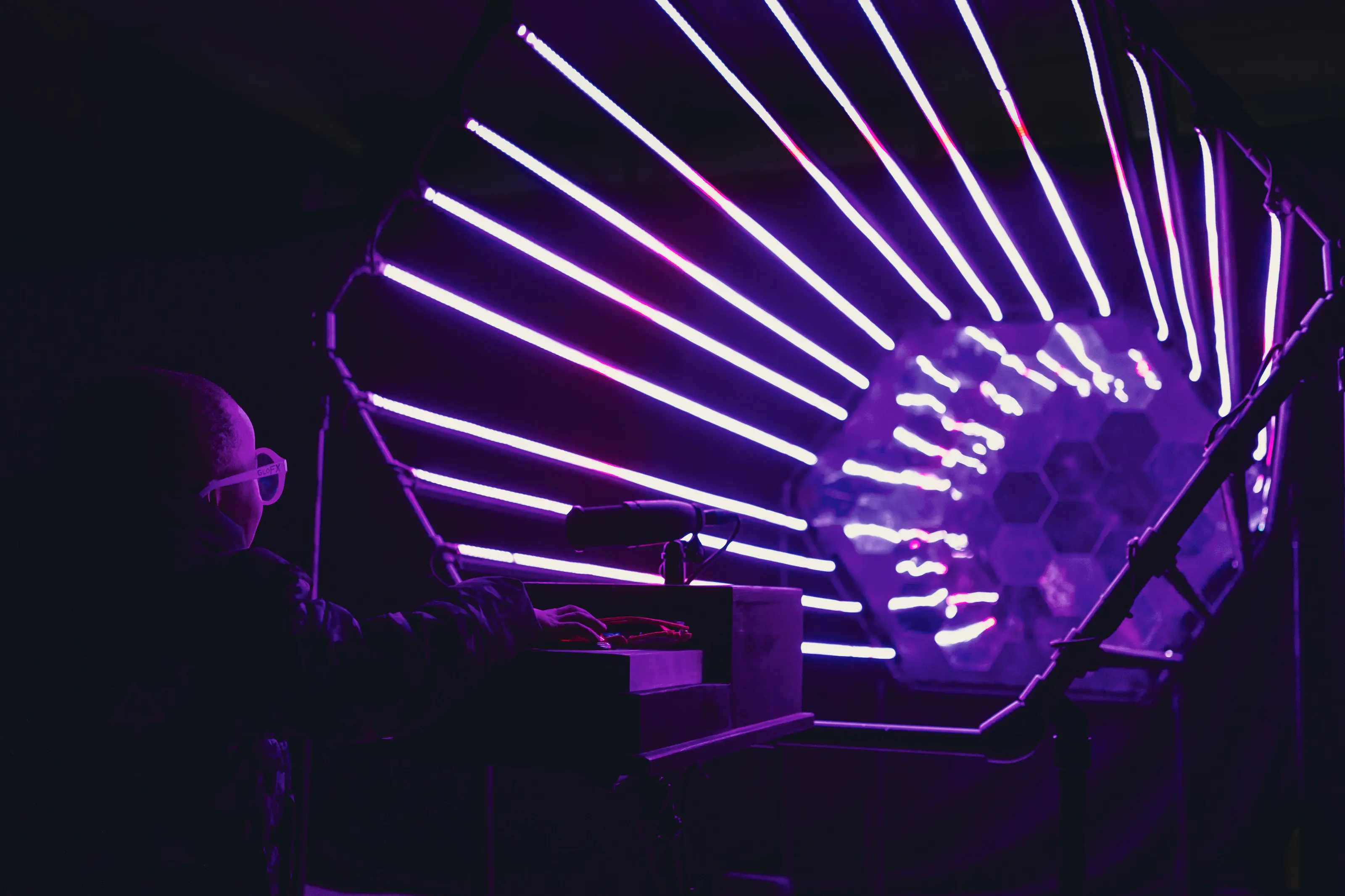 Participant facing the AI character interface while reactive lights animate around the room