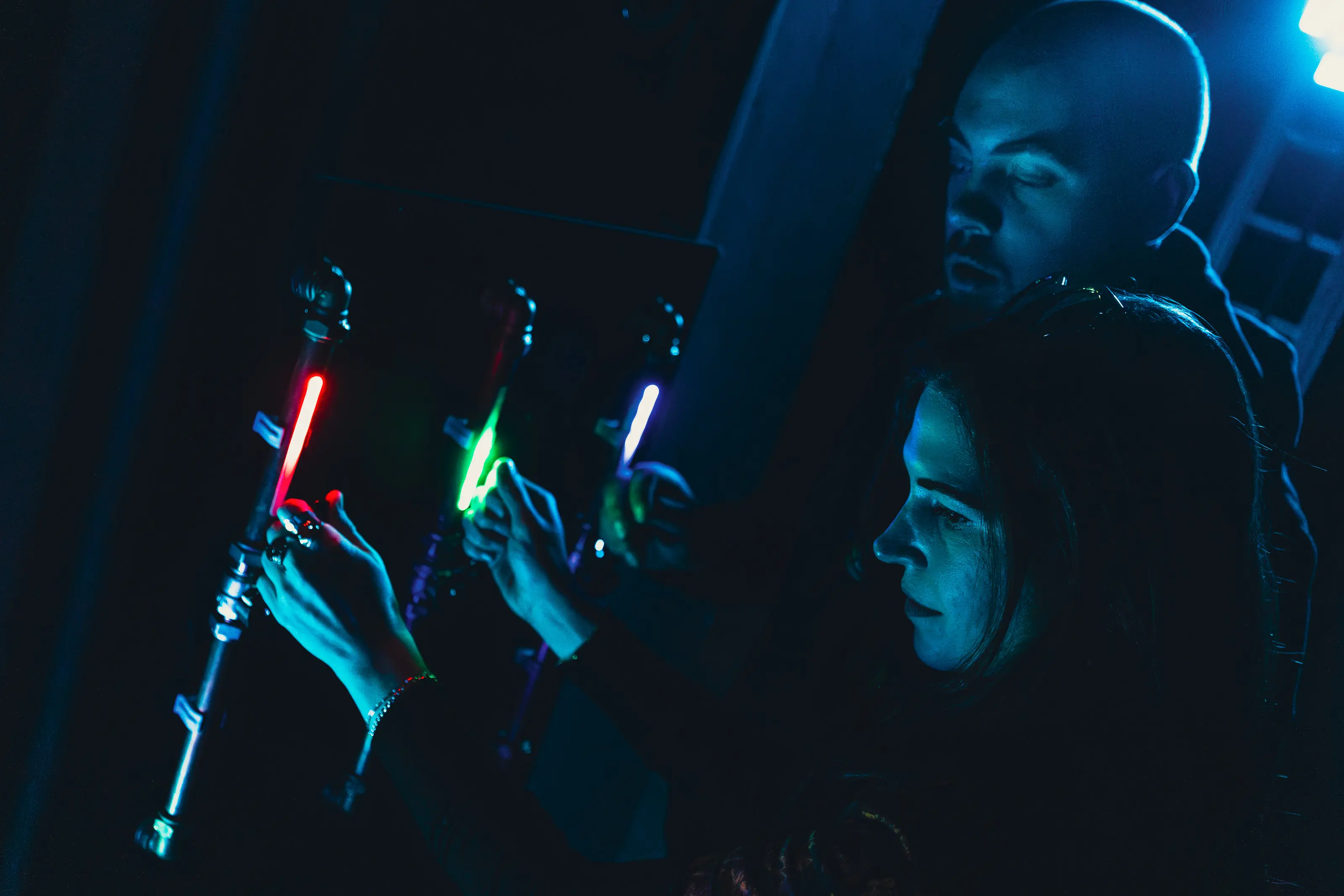 Participant using lever controls beside pipes and projected fluid visuals in the Concoct lab environment