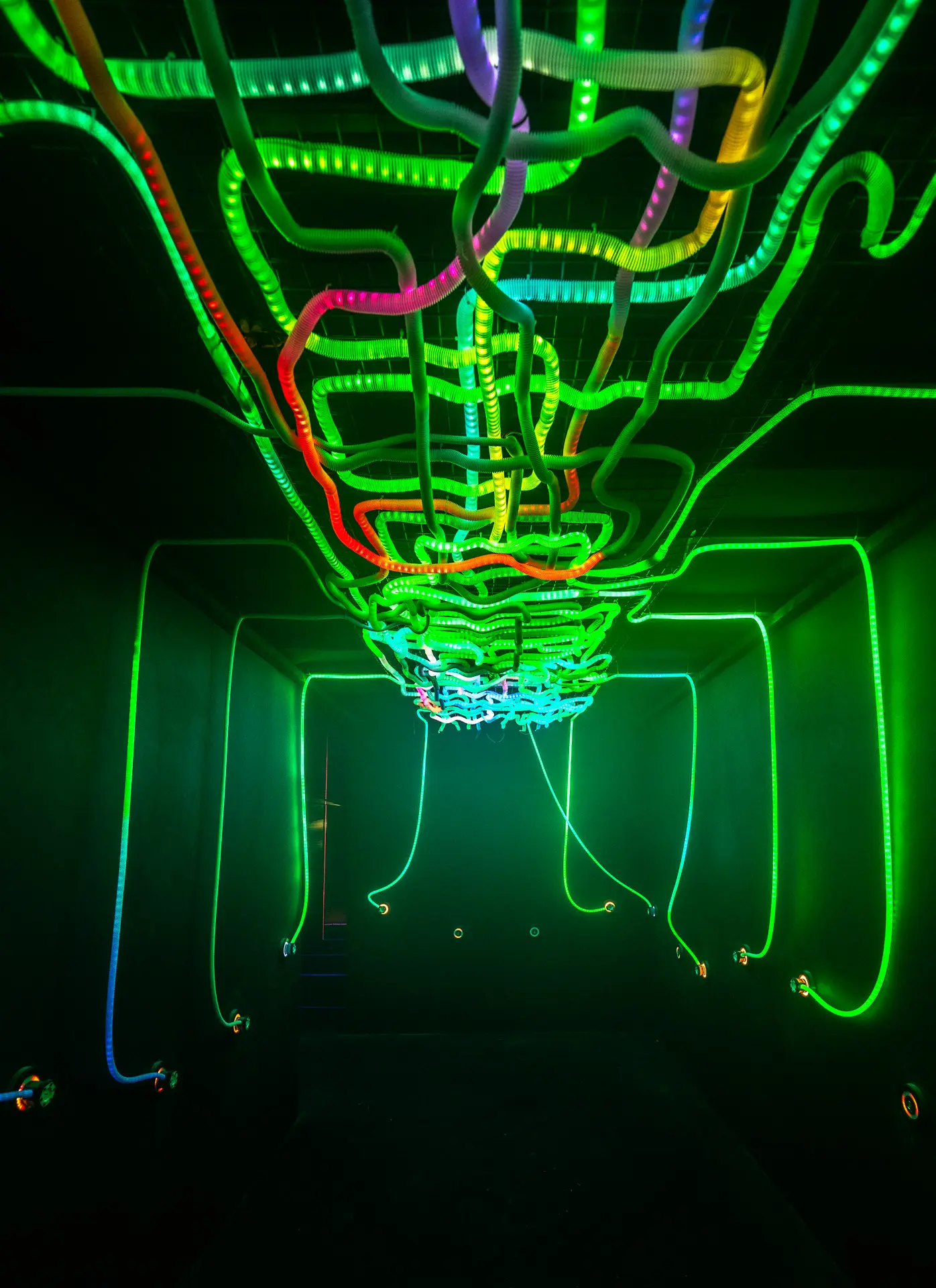 Participant patching coloured connectors while reactive lights and sound respond in real time