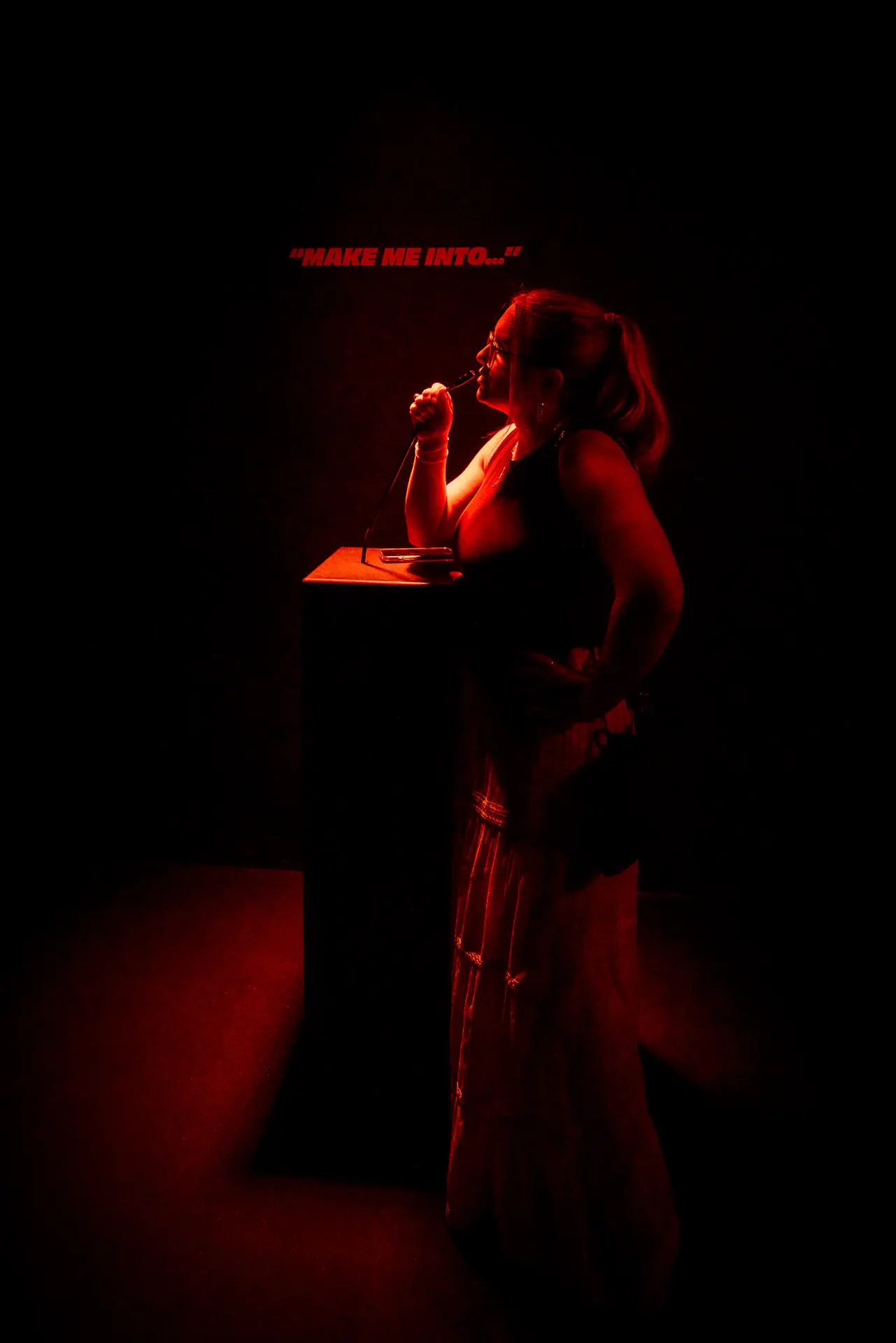 Portrait of a visitor inside the Imagine setup with generative visuals mapped to their silhouette