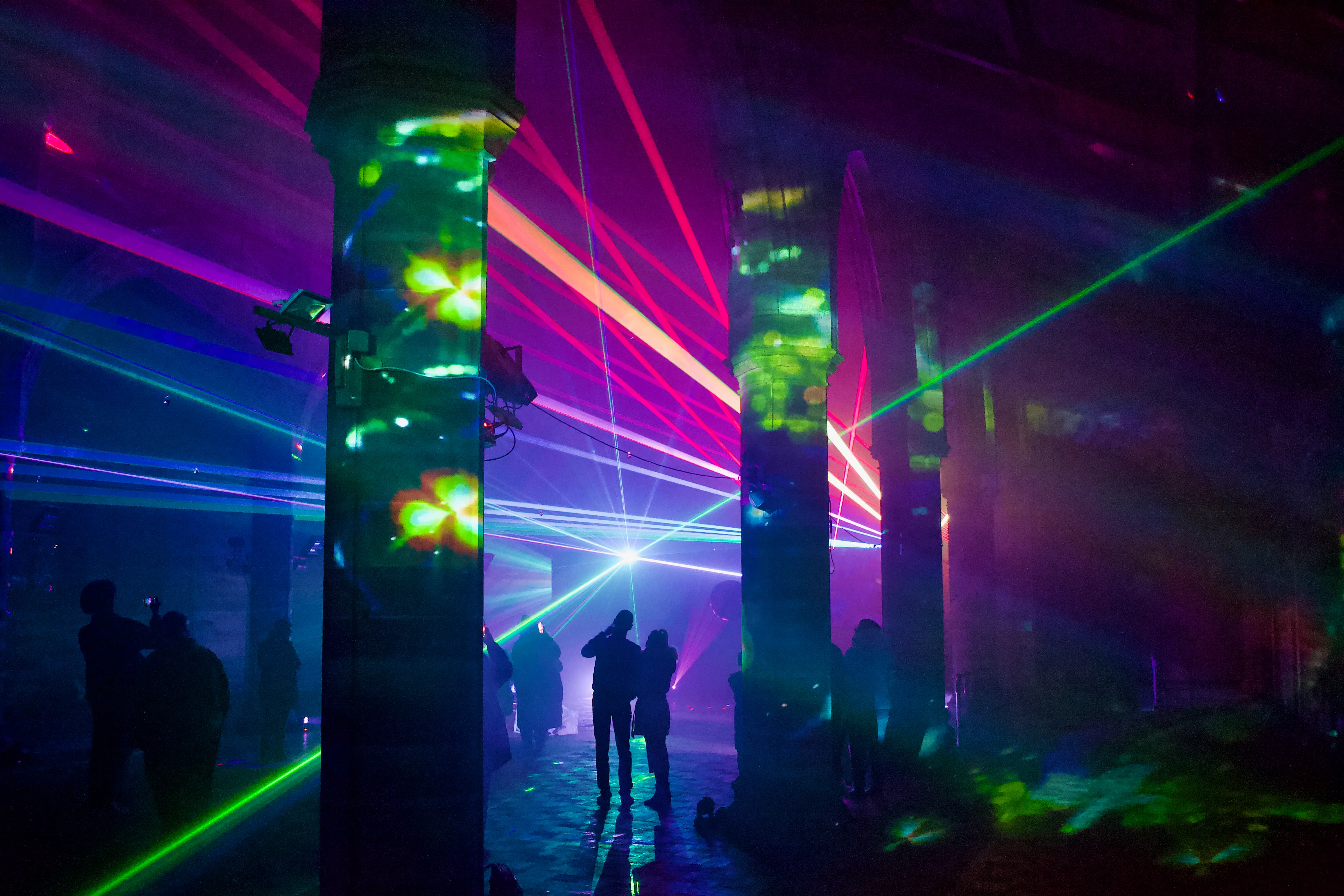 Lasers shooting between columns from Paul Alty's "Black Hole - End of Time" installation