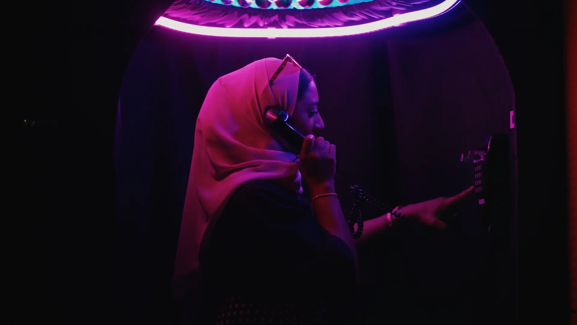 Close-up of the phone interaction station with illuminated buttons and coiled handset cable