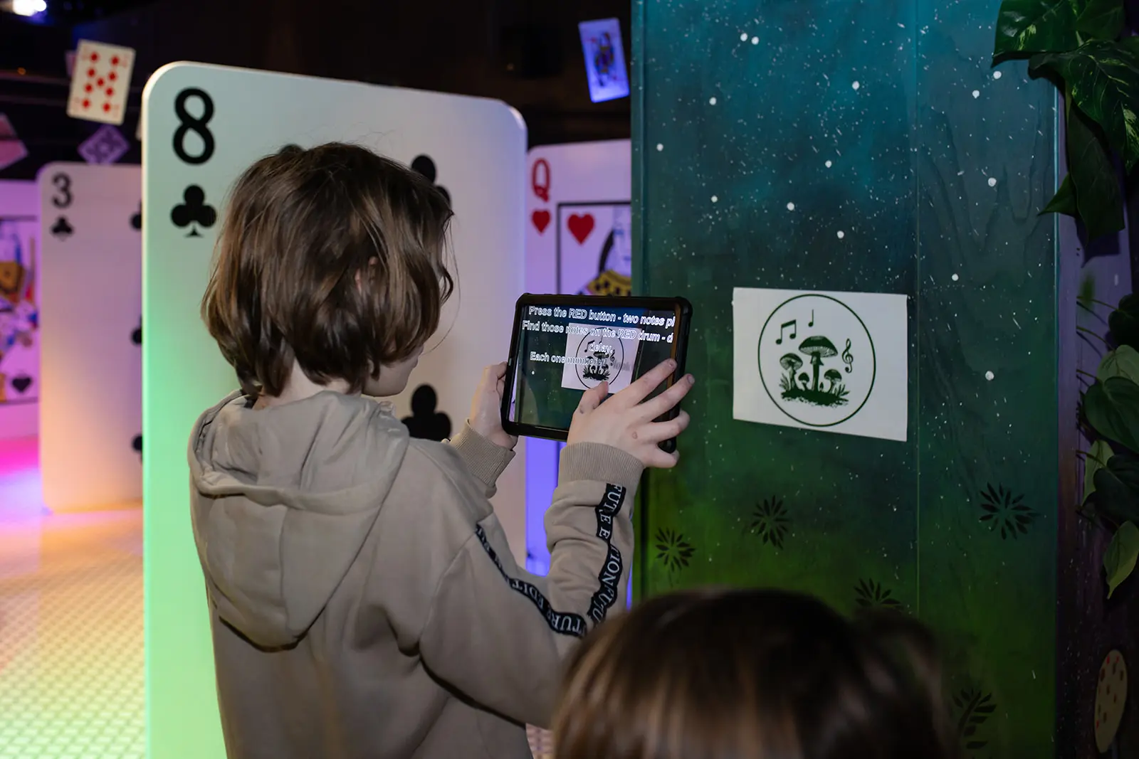 Parent and child moving through a lit narrative room during the mission experience